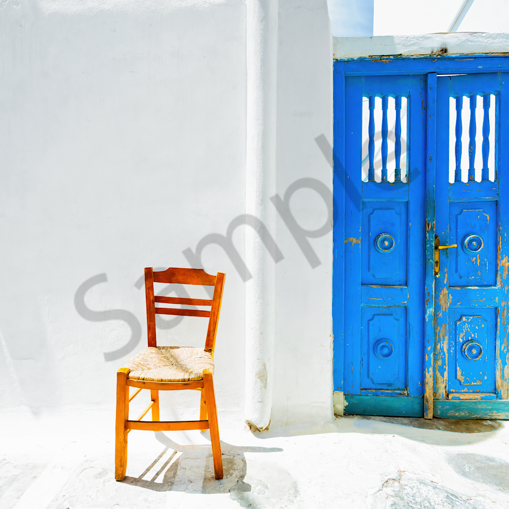 Blue door and chair in mykonos greece rmp2ku