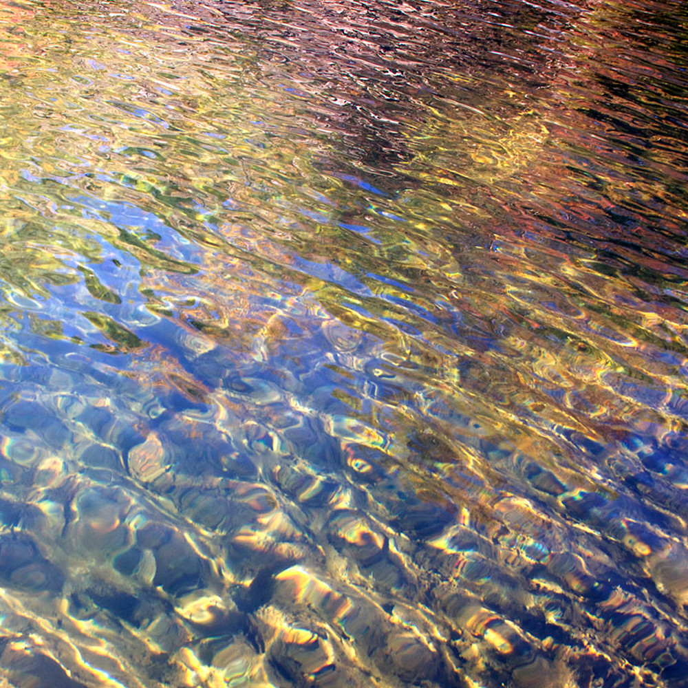 Clear water colorful reflections sun ripples f2lv8a