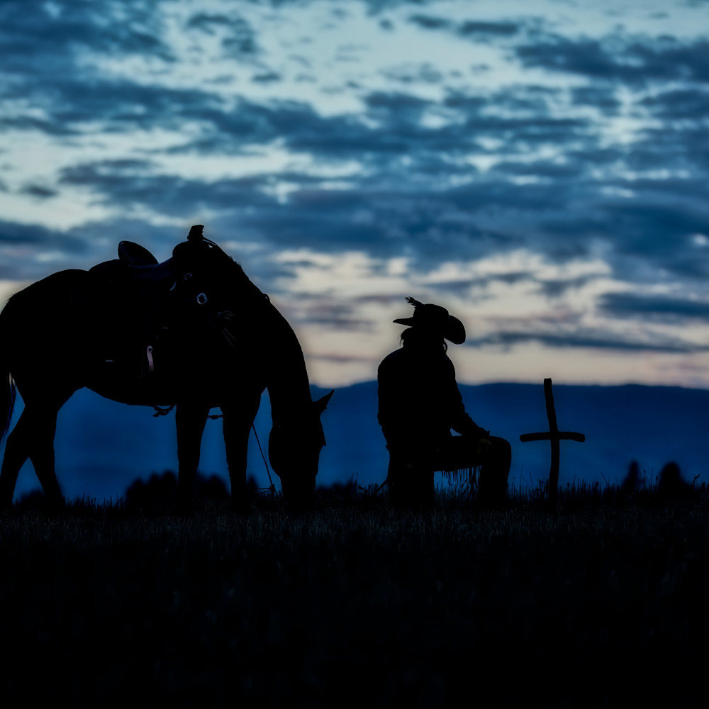 Silhouette of horse and wrangler bowing to cross djyfaj