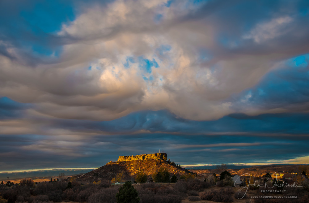 Dramatic Clouds Parting Over Castle Rock as The Rock is Illuminated