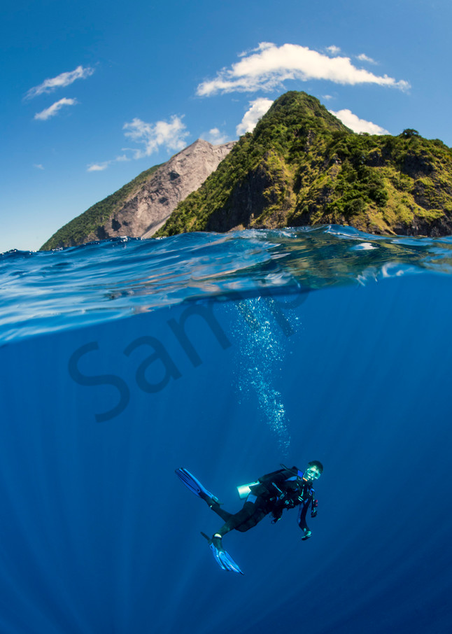 A Diver does his "safety stop" under one of Indonesia's active volcanos, Pulau Komba..Shot in Indonesia