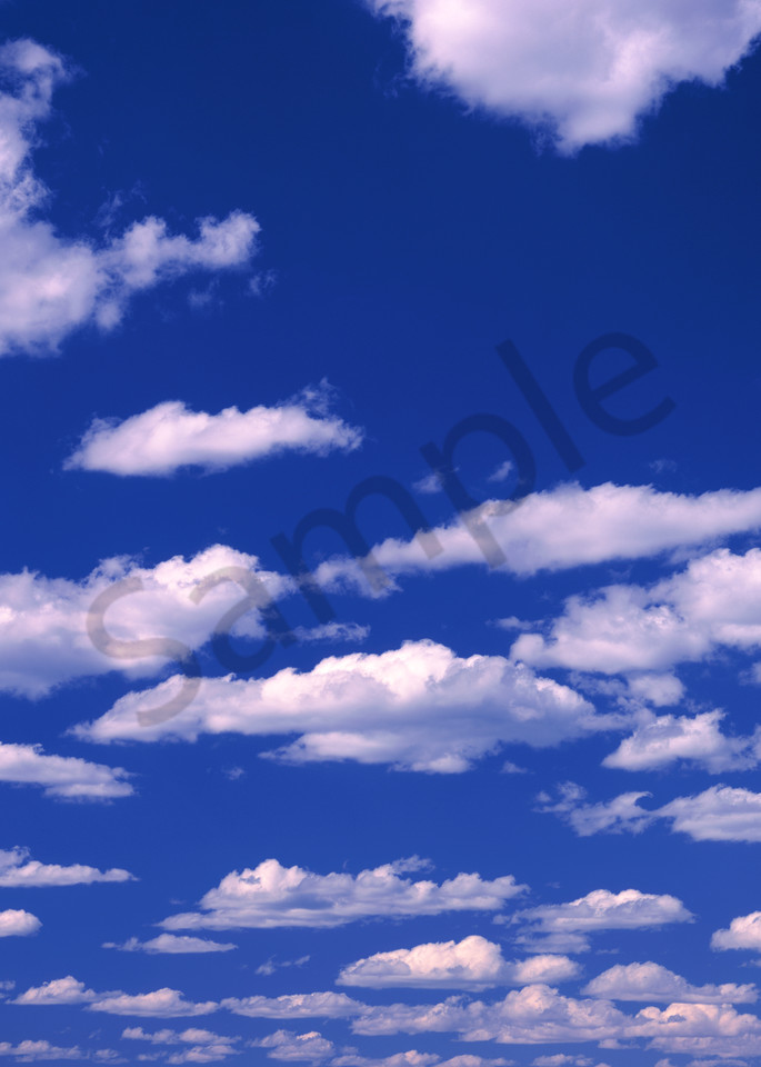 Cumulonimbus clouds against a blue sky.