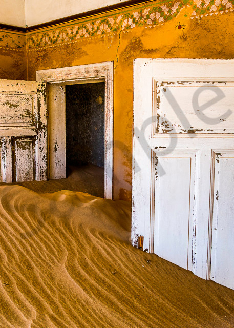 Surreal photograph art of old house filled with desert sand and morning light