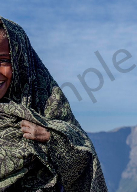 Art photograph portrait of smiling Ethiopian boy, wrapped in blanket