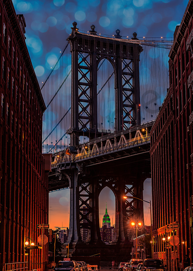 Manhattan Bridge under a decorative, twilight sky.