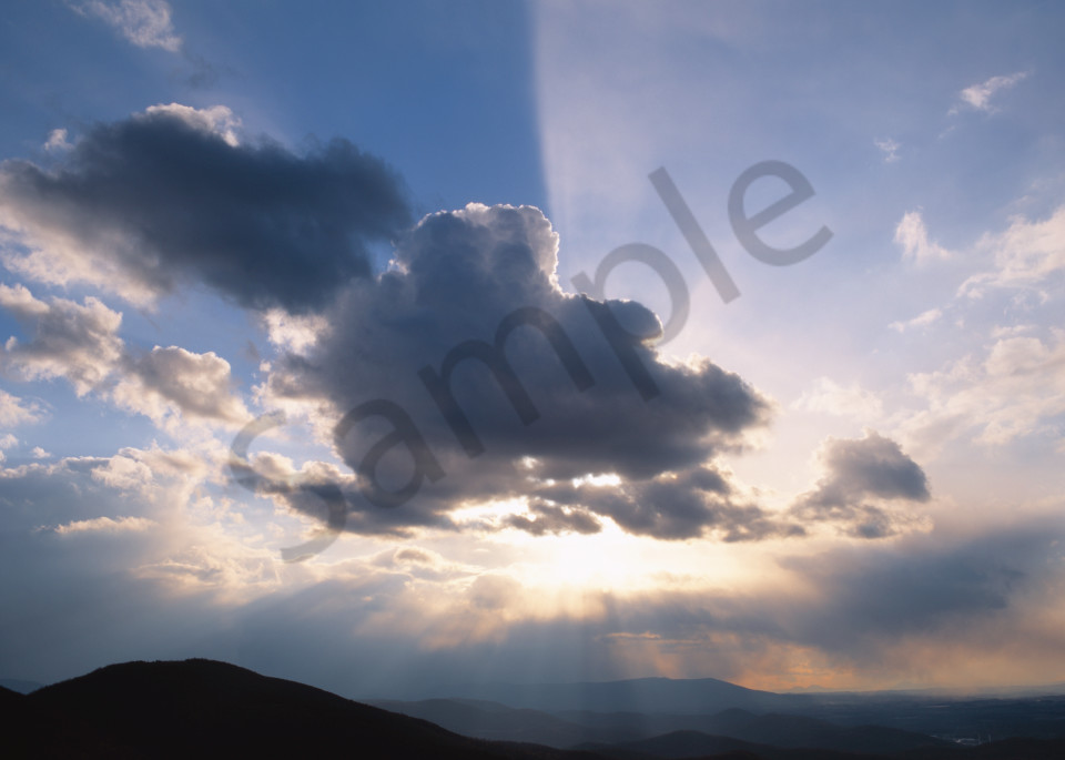 Crepuscular rays breaking out from behind a cloud