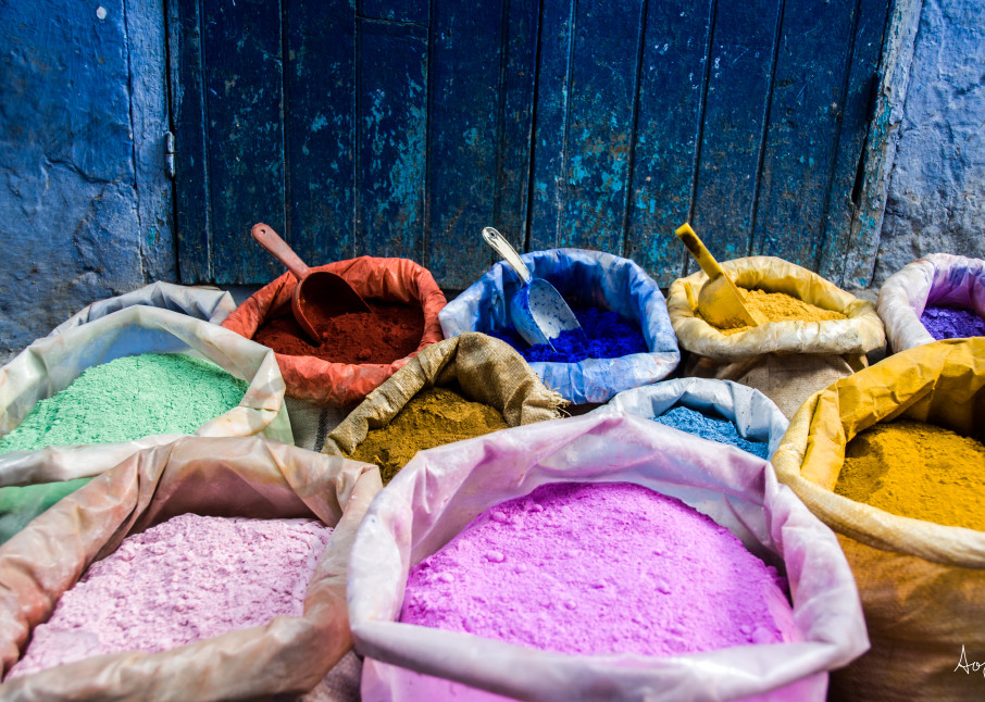 Bags of pigment dyes by blue door and wall  in a fine art photograph print