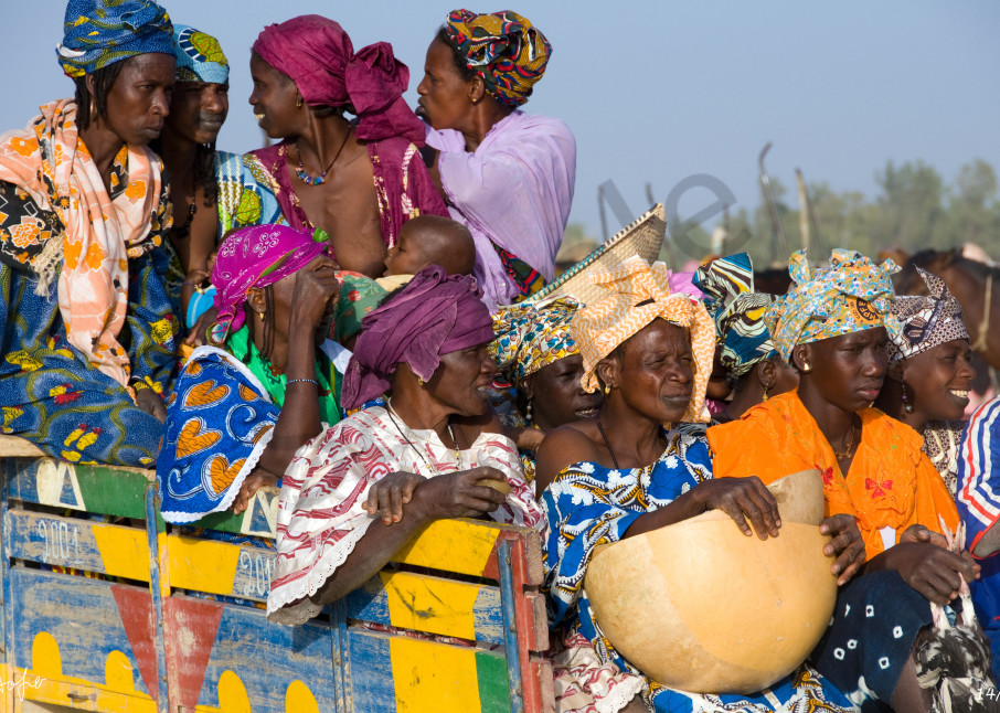 Fine art photograph of a group of Fulani woman in colorful clothes after market day
