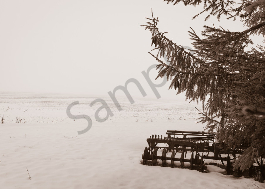 Sepia country & ruralscape photograph of an antique disc harrow plow in a foggy and snow-covered rural Ontario field, for sale as fine art by Sage & Balm