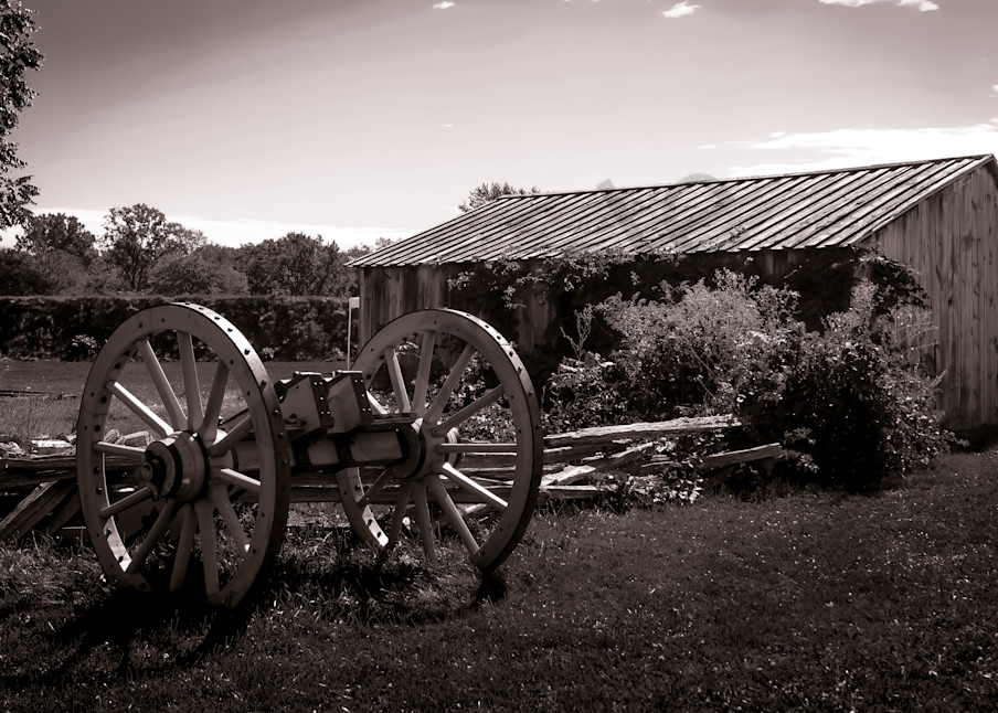 Sepia photograph of an antique cannon wagon and barn from historic Fort George, Niagara-on-the-Lake, for sale as fine art by Sage & Balm