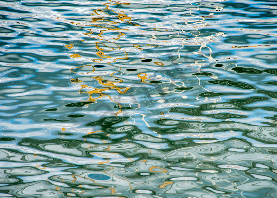 Fine art photograph, abstract reflections on water ripples in gold and blue