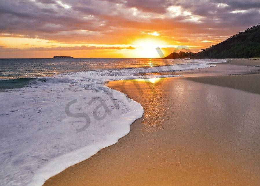 This is a photo of one of the most famous beaches on Maui called Big Beach. Its located in Makena, Maui and is a favorite spot for the locals and young people. Molokini crater can be seen in the background of this golden sunset.