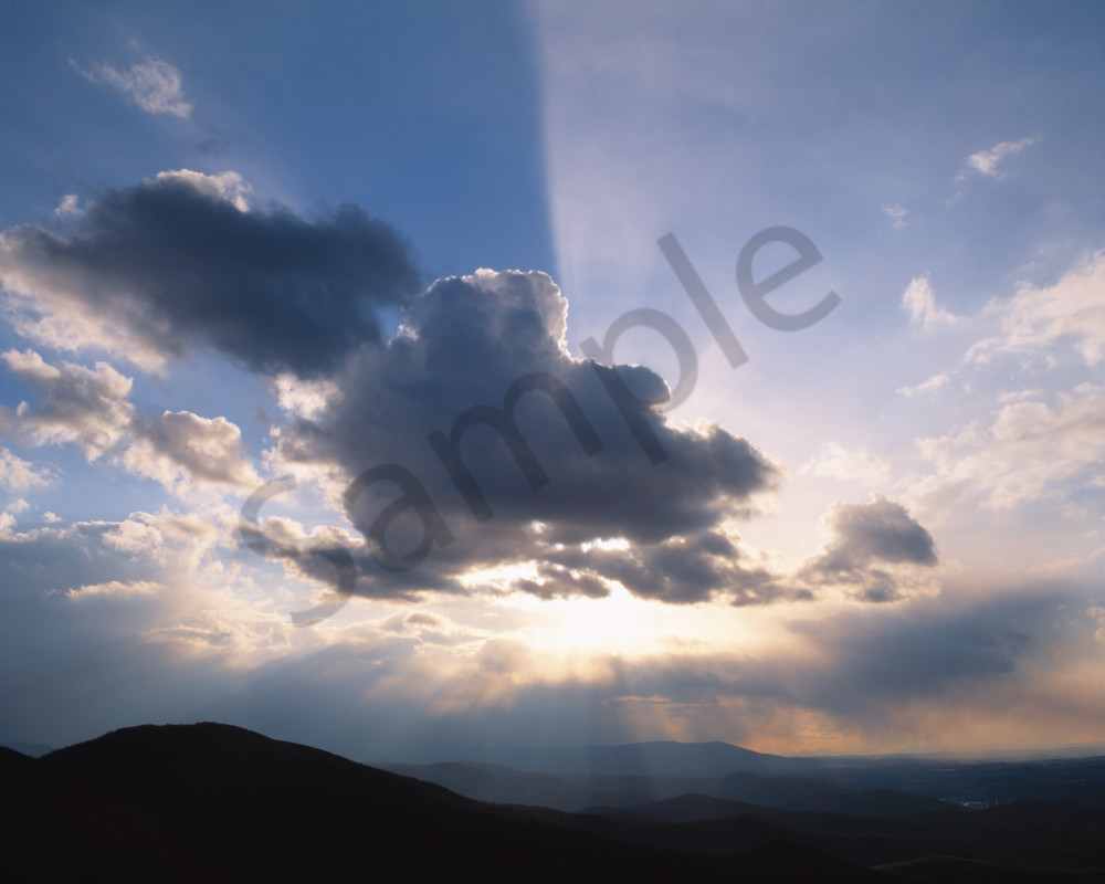 Crepuscular rays breaking out from behind a cloud