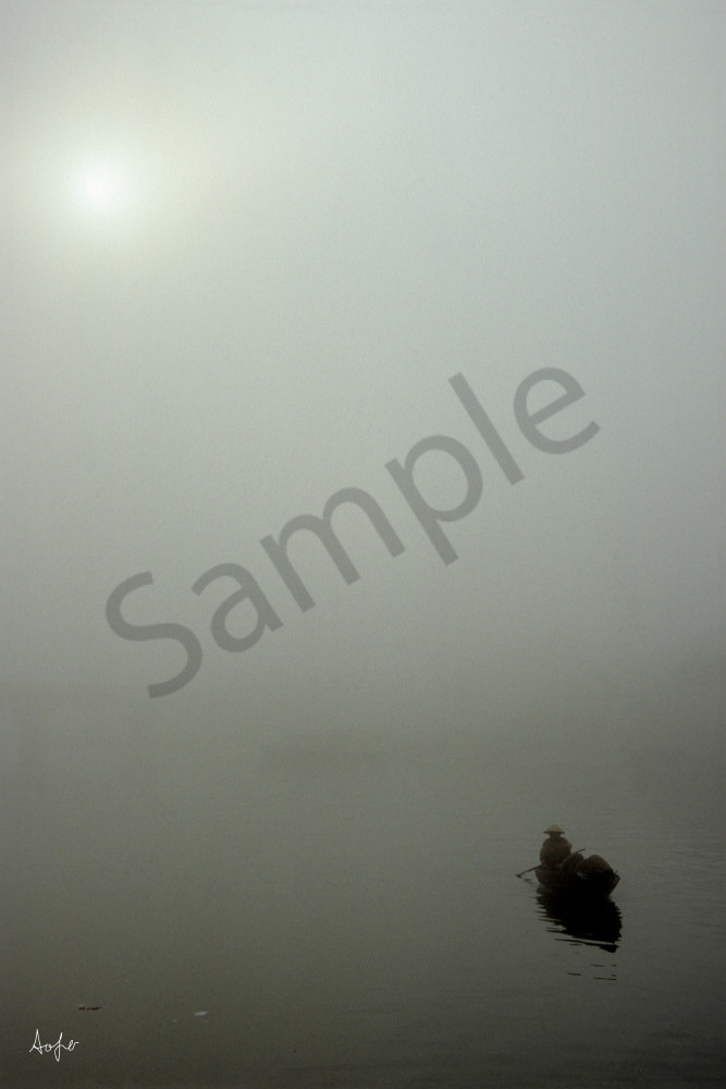 small boat on misty river with gray foggy background