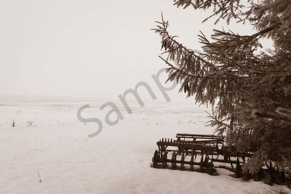 Sepia country & ruralscape photograph of an antique disc harrow plow in a foggy and snow-covered rural Ontario field, for sale as fine art by Sage & Balm
