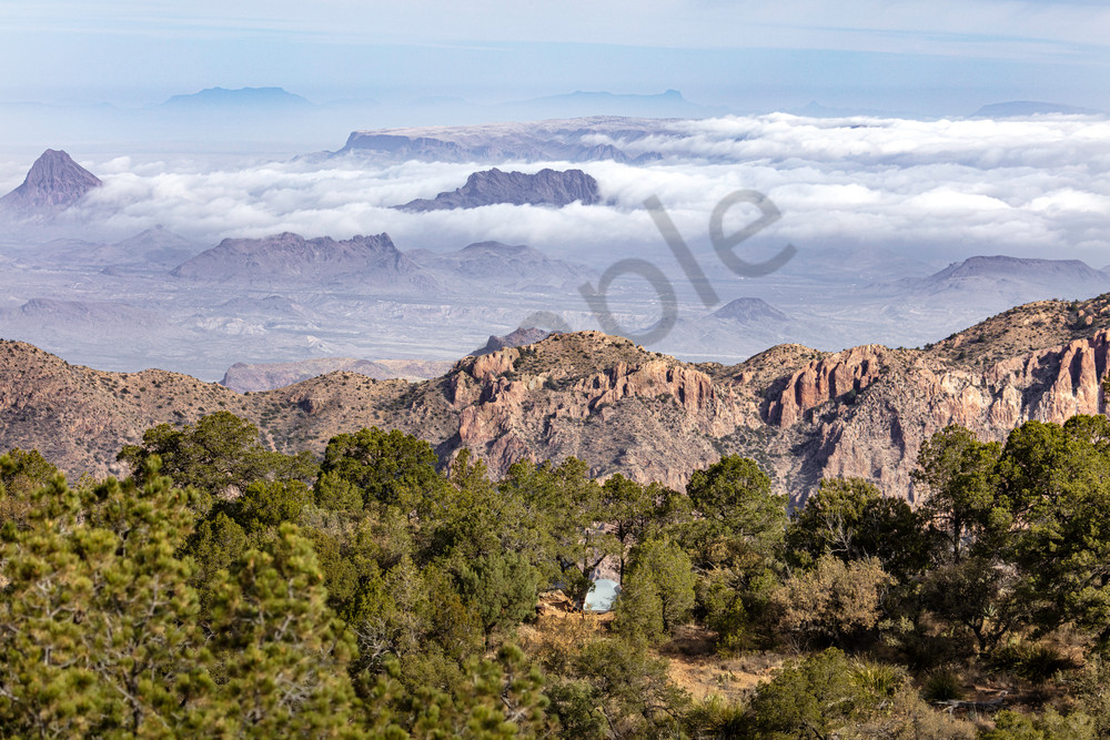 A campsite overlooking clouds acting like waves of water against the mountains at Big Bend National Park in Texas. 