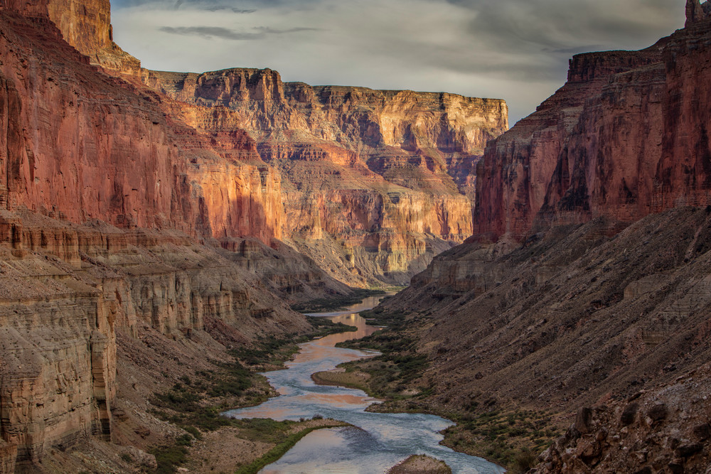 Standing above the Colorado River looking in Grand Canyon National Park at sunset