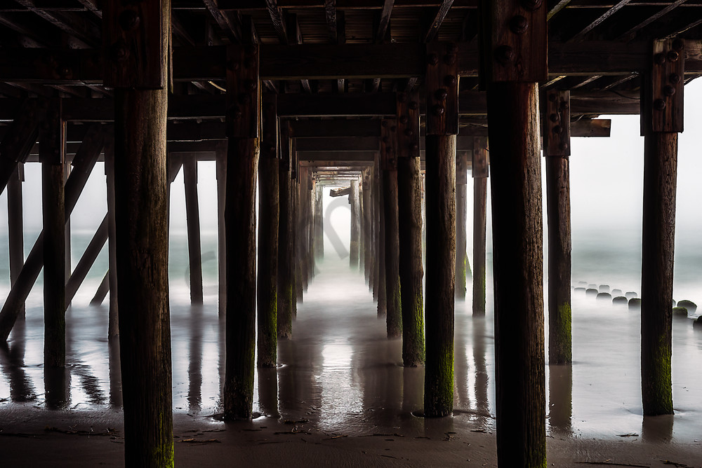 Eerie view under pier in fog