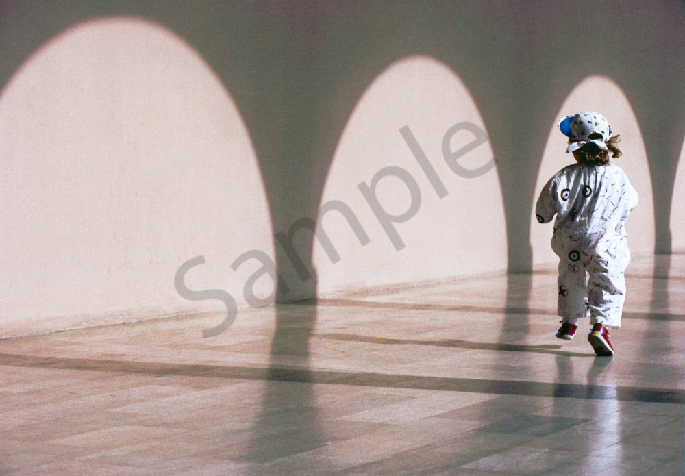Two year old girl running in the colonnade shadows of the Ringling Museum, Sarasota, Florida Two year old girl running in the colonnade shadows of the Ringling Museum, Sarasota, Florida