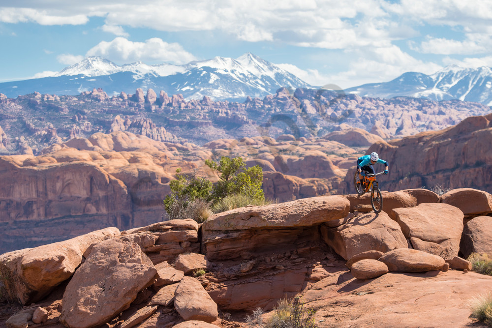 Nathaniel Hills Riding his Mountain Bike on Slickrock in Moab in Southern Utah on a Sunny Day