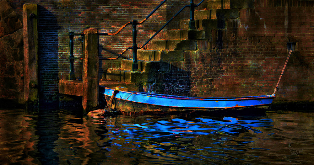 Antique look of a blue boat tied to a wall in Amsterdam