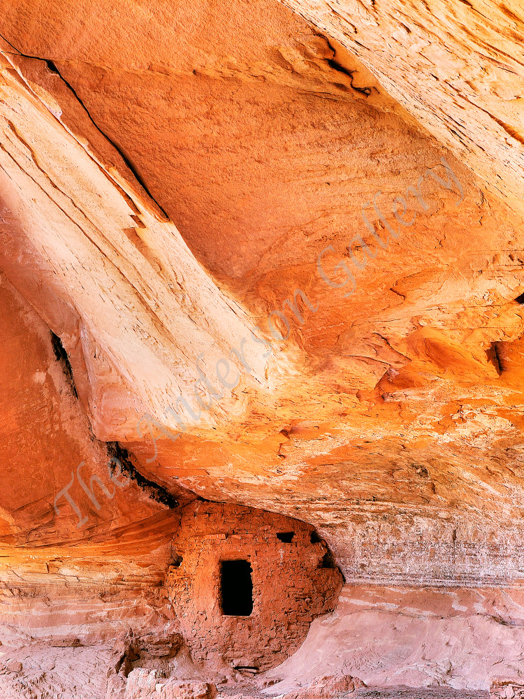 An abstract of a small grainary in a large cliff dwelling.