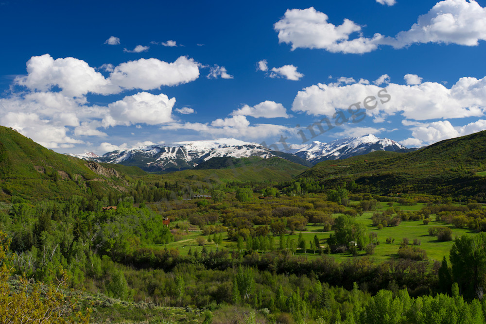 mountain light images snowmass ski area from watson divide may sunny day with clouds snow and green valley