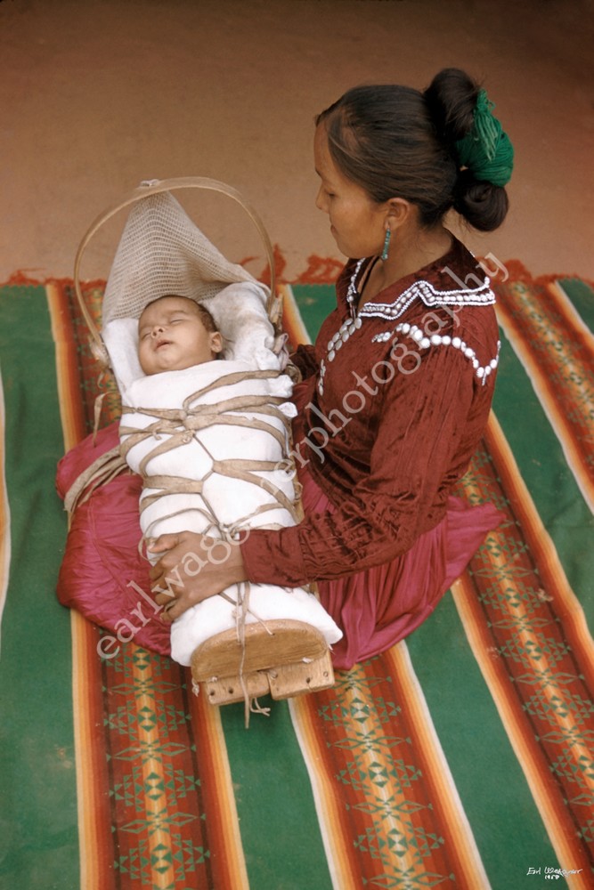 Woman on Blanket with Child in Cradleboard
