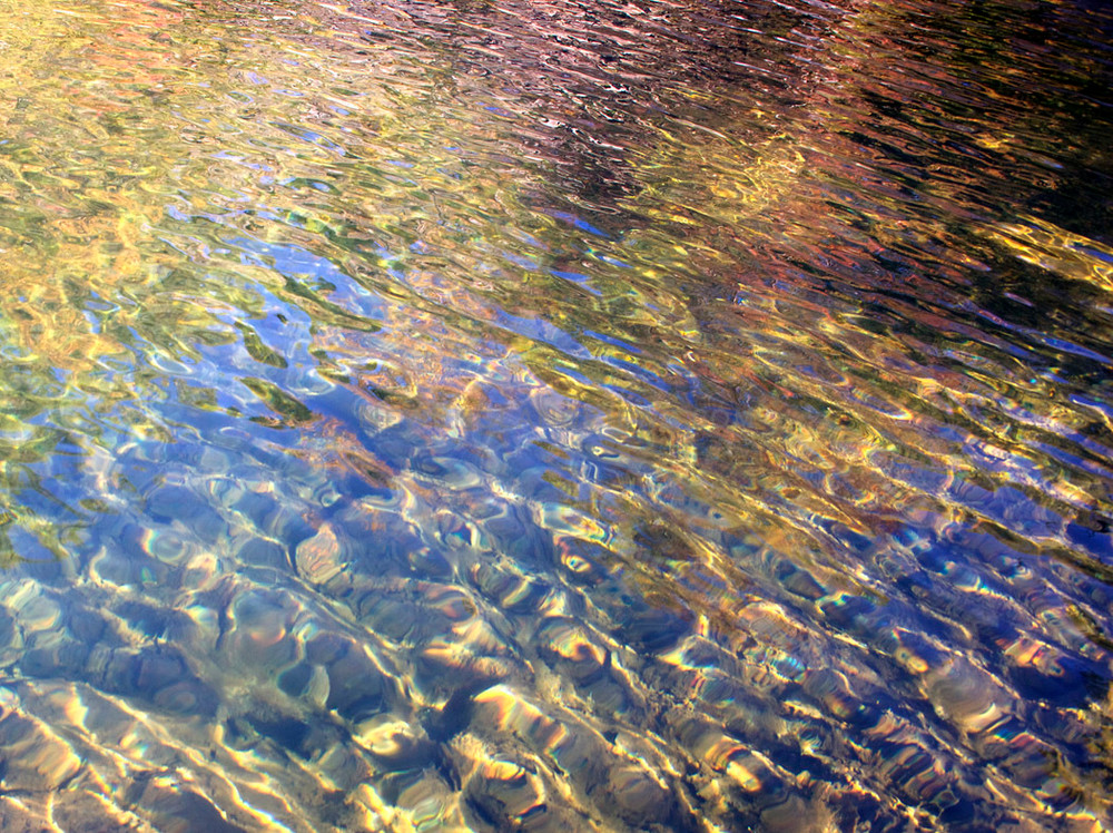 clear water colorful reflections sun ripples