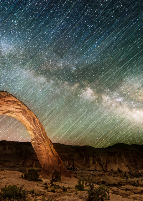 Corona Arch Celebration. Utah's Corona arch with milky way and star trails by Mike Taylor of Taylor Photography.