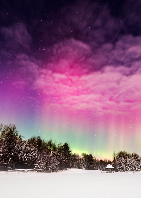Moonlight Aurora, moon shines on a winter field while aurora borealis peeks through the clouds
