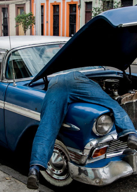Man in engine of old classic blue car, art photograph print