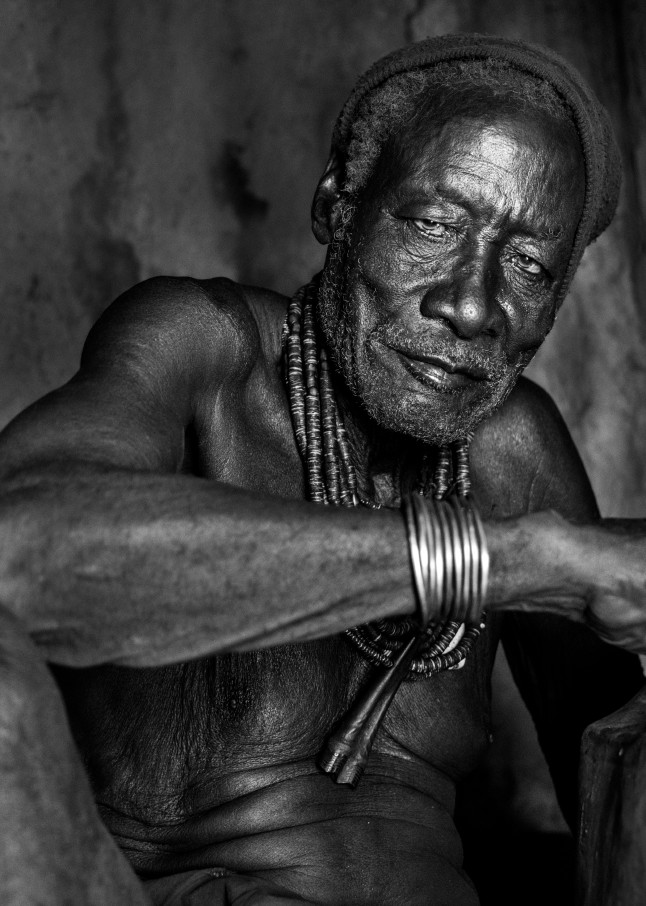 Himba chief in hut in black and white portrait