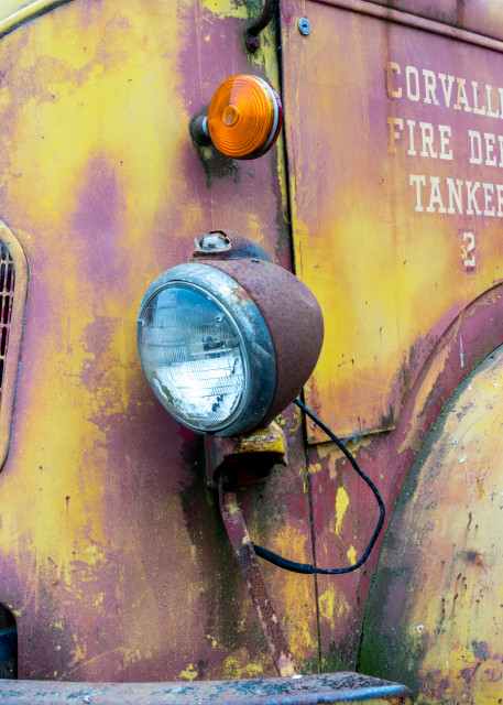 An old fire truck in yellow and pink with nice front grille in art photograph