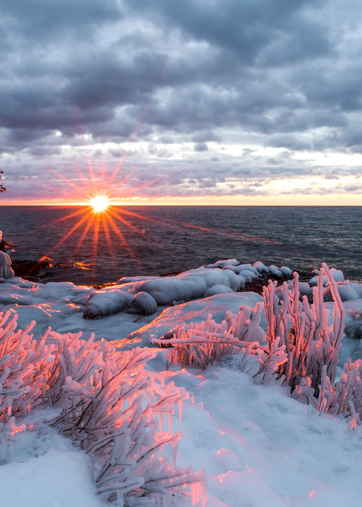 Ice covered shoreline at sunrise