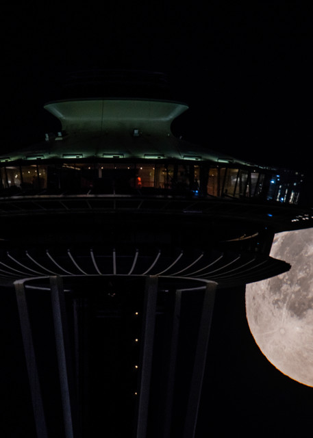 Full moon setting behind Space Needle