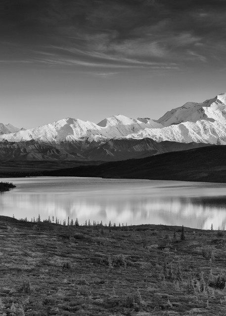 Alpenglow on Denali (Mt. McKinley) and the Alaska Range with Wonder Lake in foreground in Denali National Park in late fall in Southcentral Alaska. Evening.