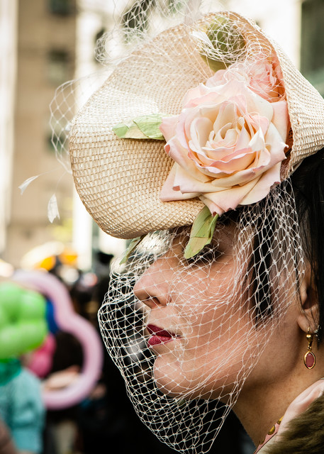 New York, NY - 8 April 2012. A woman in a hat and veil reminiscent of the 1940s in New York City's Easter Parade and Bonnet Festival on Fifth Avenue.