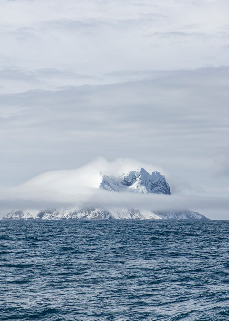 Ice and snow covered island in the distance, Gerlach Strait | Nicki Geigert, Photographer