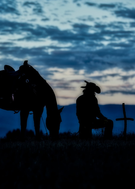 Silhouette of Horse and Wrangler Bowing to Cross