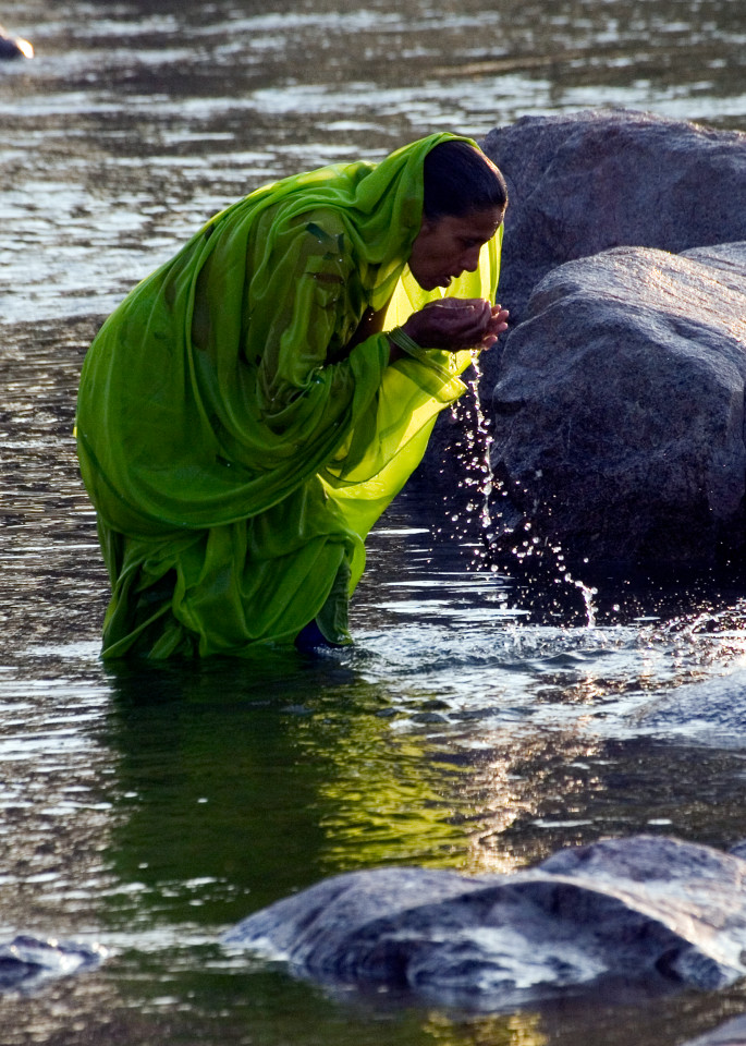 Woman bathing in river in Orchha India