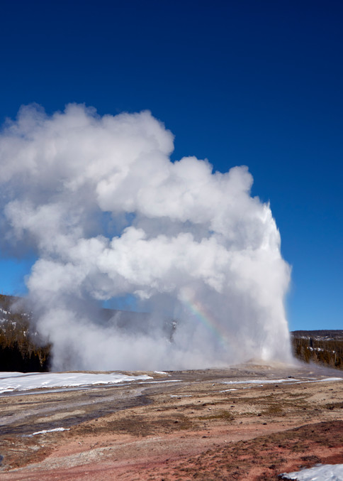 The Old Faithful geyser faithfully erupts in the Wyoming portion of Yellowstone National Park, which makes up the lion's share of the nation's first national park.  Small pieces of the park also spill into neighboring Idaho and Montana.  Old Faithfu