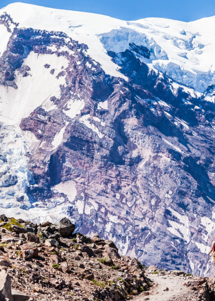 A woman hiking on First Burroughs Mountain below Mount Rainier, Washington, USA