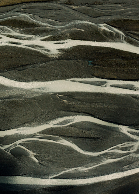 A dramatic and abstract aerial photograph of the glacial rivers in New Zealand by fine art photographer Allison Davis