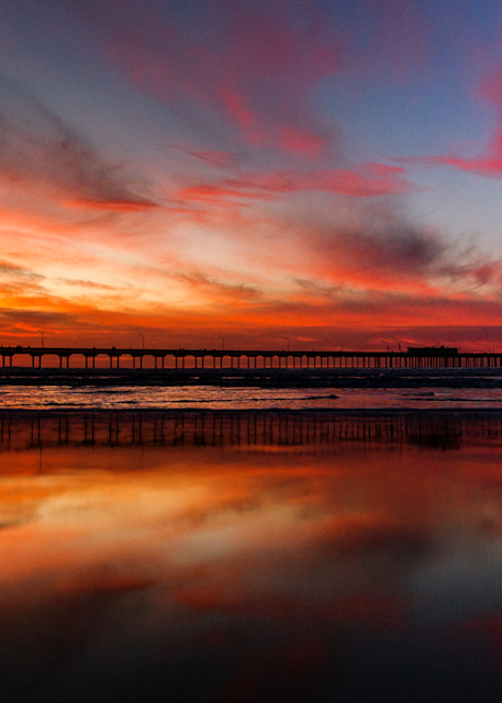 A fine art landscape of the Ocean Beach pier with a low tide sunset with reflective waters in San Diego by photographer Allison Davis