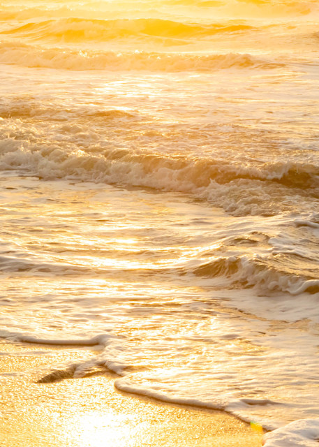 The golden sunrise reflecting off ocean waves