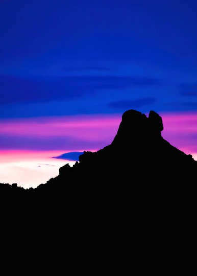Desert Sunset Sky with Bands of Color and Mountain in Silhouette