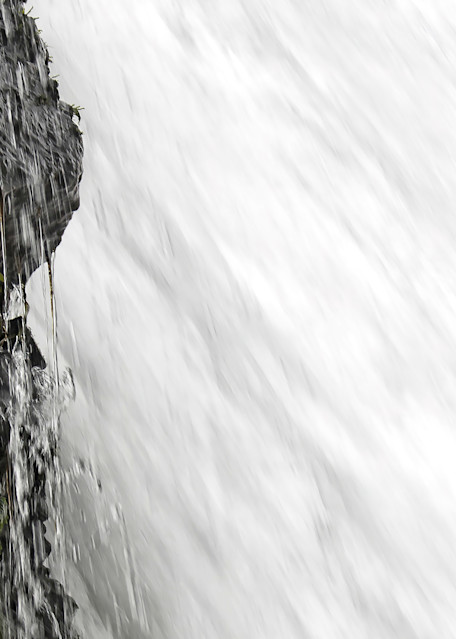 Close Up Underneath Big Waterfall and Dripping Cliff