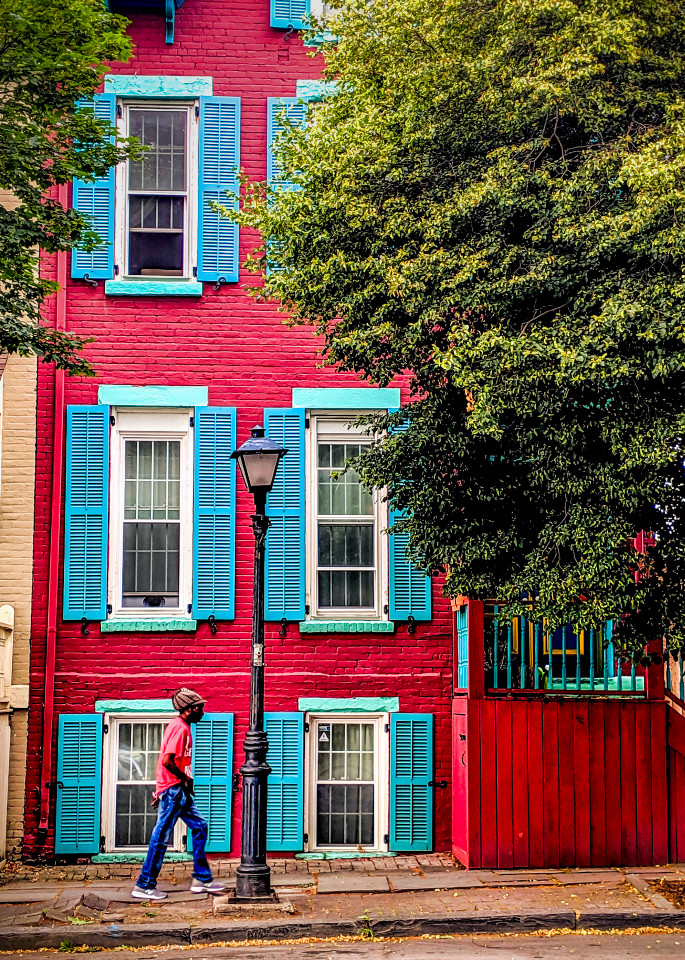 Man Walking By Red House