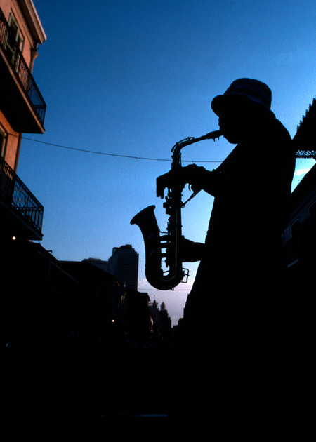 French Quarter street musician plays his sax for spare change in New Orleans, Louisiana.